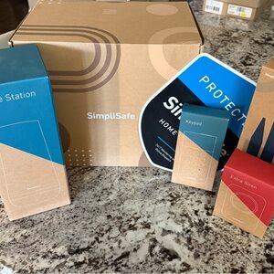 SimpliSafe security kit with blue, tan, and red boxes